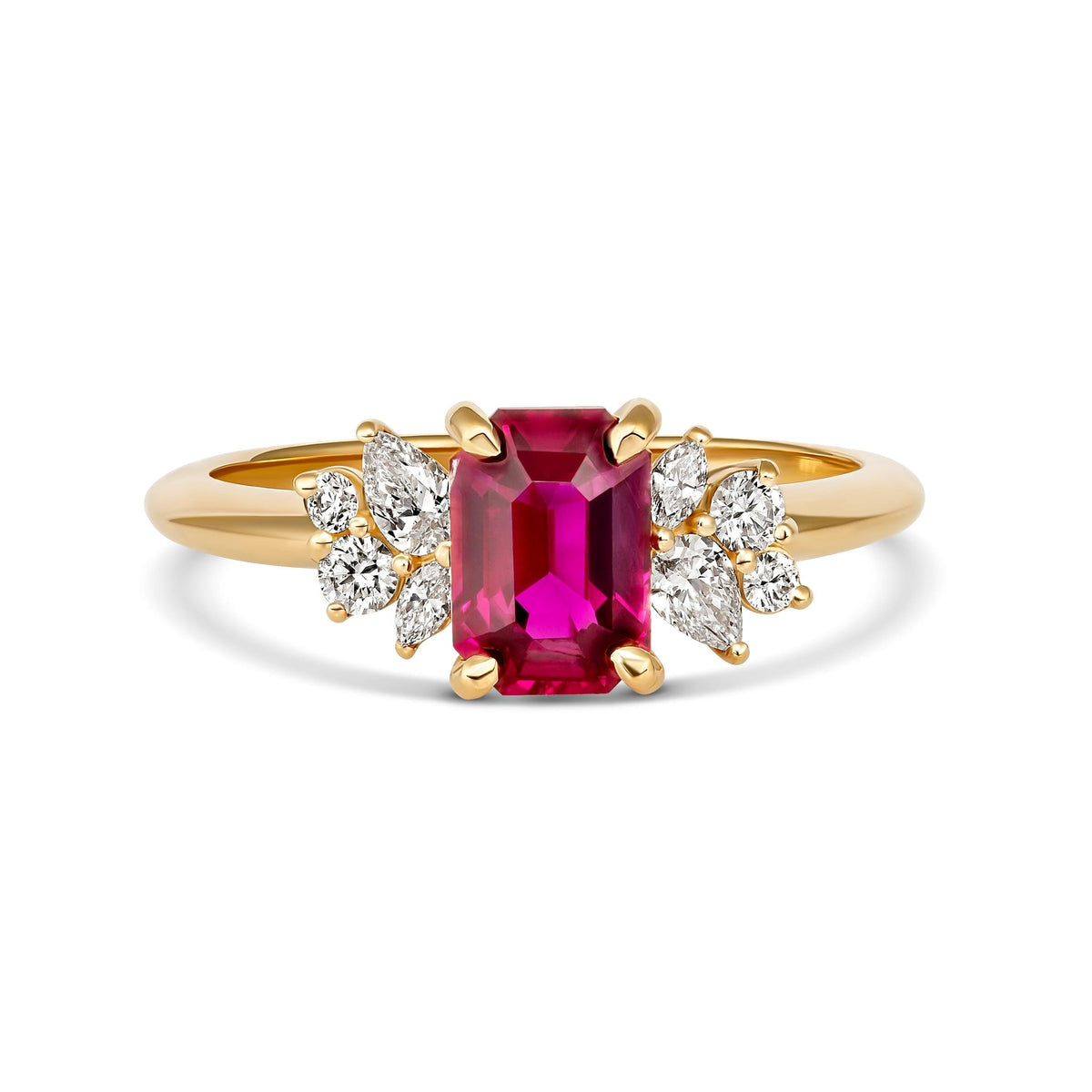 Frontal studio shot of an emerald cut red ruby ring flanked by asymmetric diamond clusters