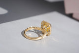 Close-up of yellow sapphire halo ring in natural light