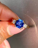 Three-stone sapphire ring with diamonds in natural light