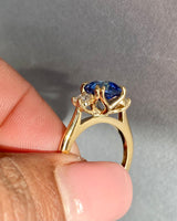 Blue sapphire diamond trilogy ring close-up