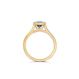 Oval sapphire bezel ring in yellow gold, side profile view