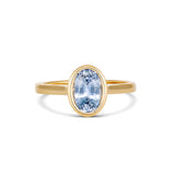Sky blue oval Ceylon sapphire in yellow gold bezel setting