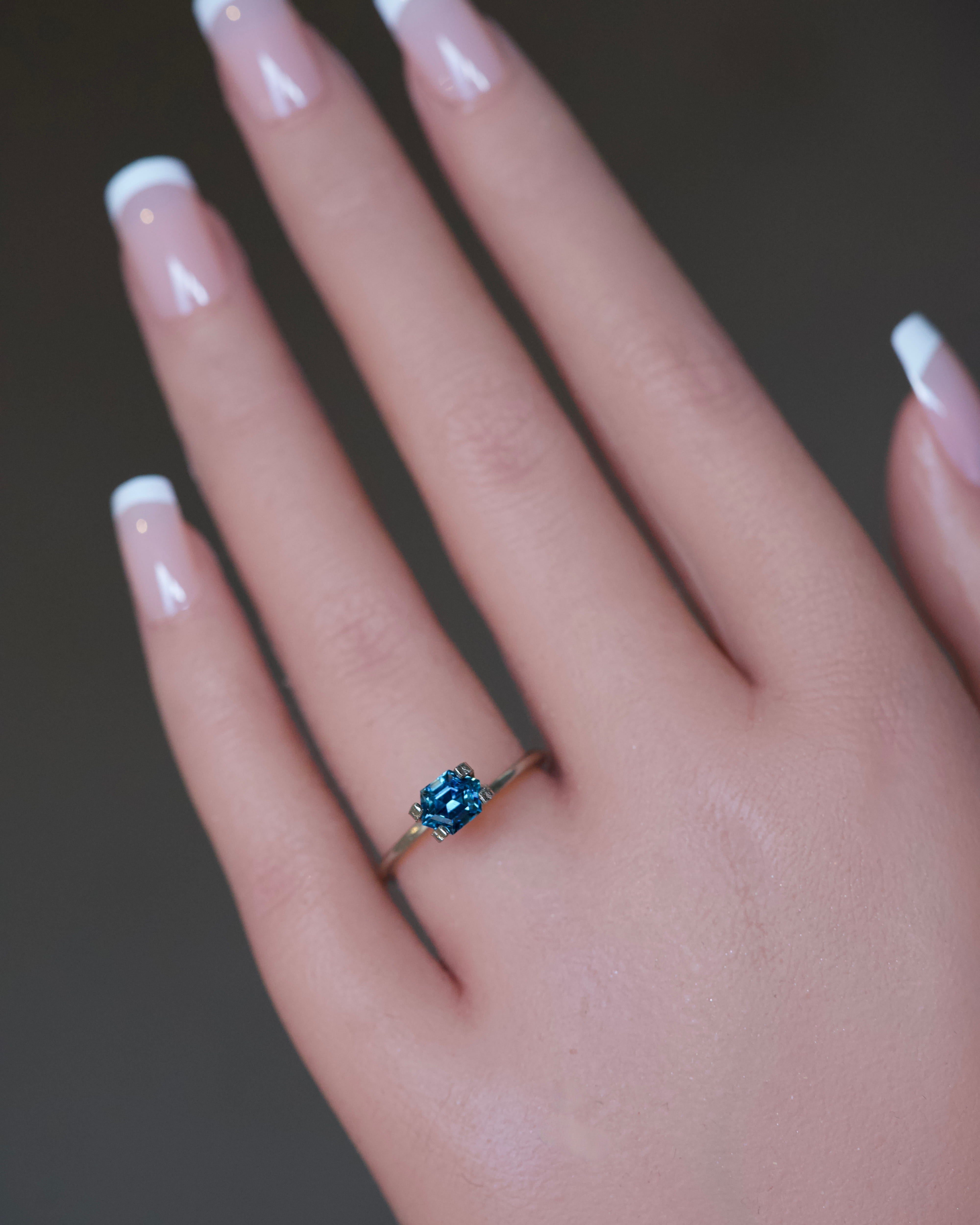 Custom geometric fancy-cut bluish green Madagascar sapphire modeled in a delicate ring setting.