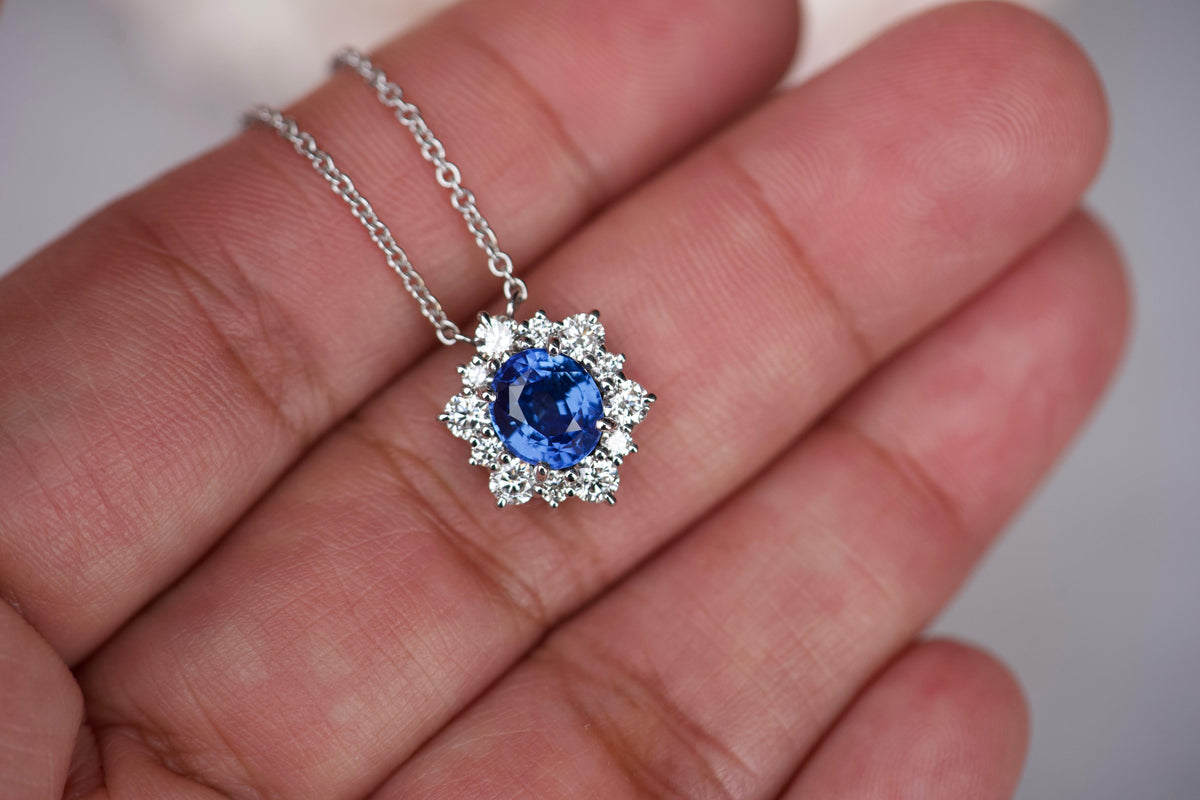 Sapphire diamond pendant in hand showing scale