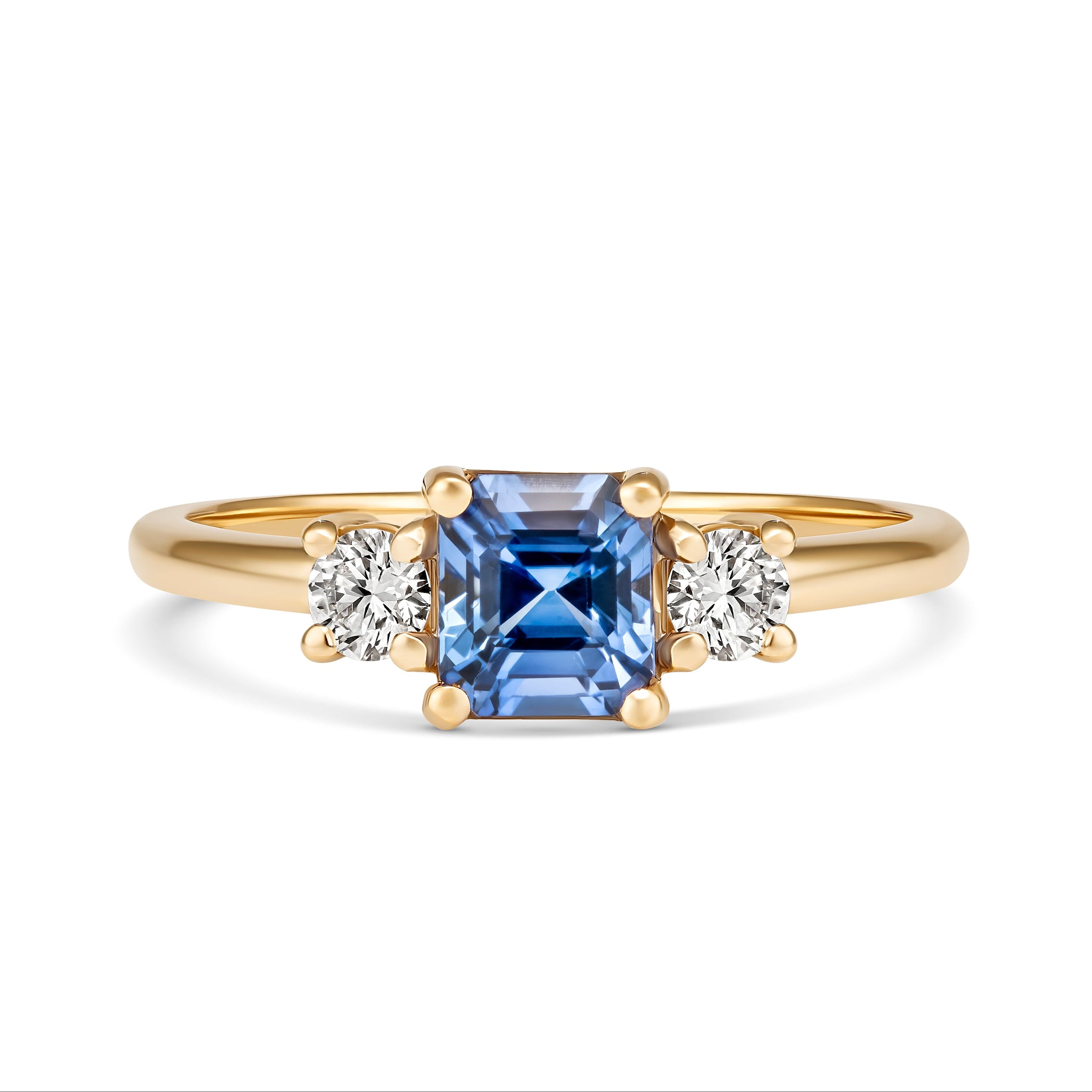 Blue sapphire three stone ring with diamond accents