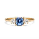 Blue sapphire three stone ring with diamond accents