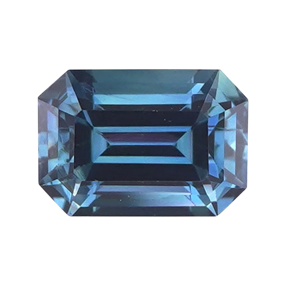 Rectangular step-cut teal blue sapphire with neatly truncated corners.