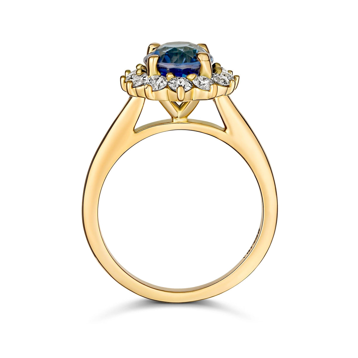 Side profile of an 18k yellow gold starburst halo ring with a cushion cut blue sapphire