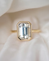 Emerald cut champagne sapphire bezel ring, top view