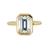 Emerald cut champagne sapphire bezel ring in yellow gold