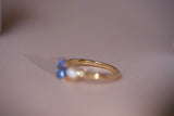 Interior view of custom sapphire ring showing Deliqa brand engraving inside 18k yellow gold band with blue sapphire visible