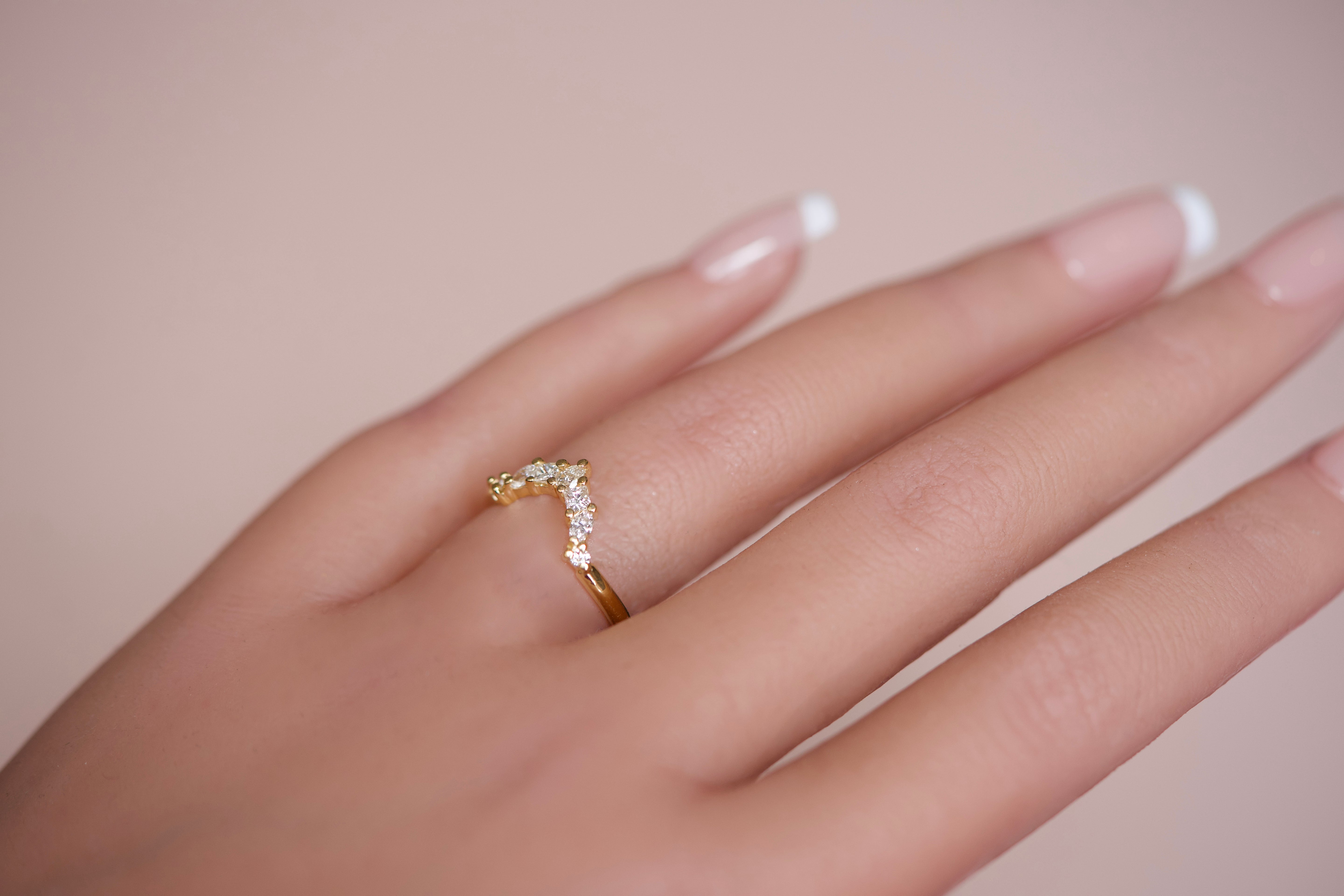Diamond crown wedding band worn on hand, close-up