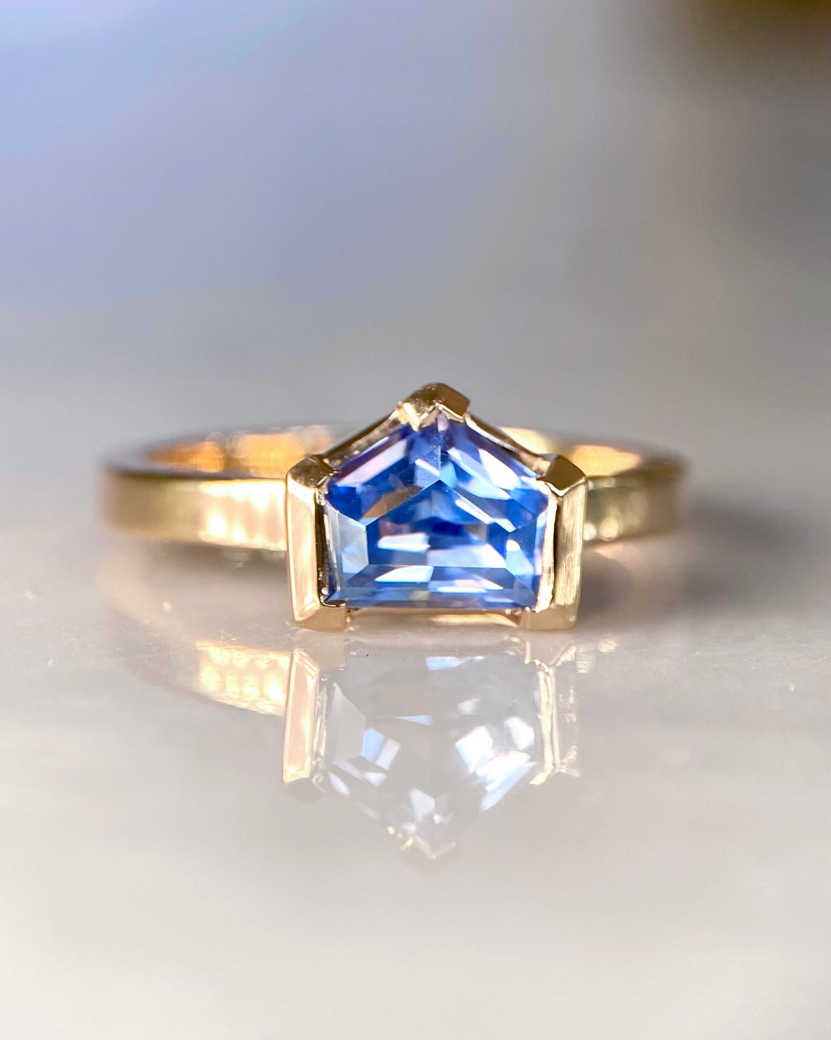 Fancy cut blue sapphire ring worn on hand, lifestyle