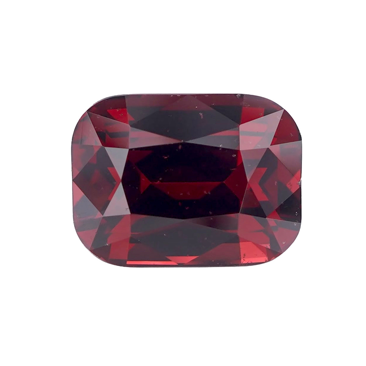 Loose rectangular cushion-cut orangish red rhodolite garnet.
