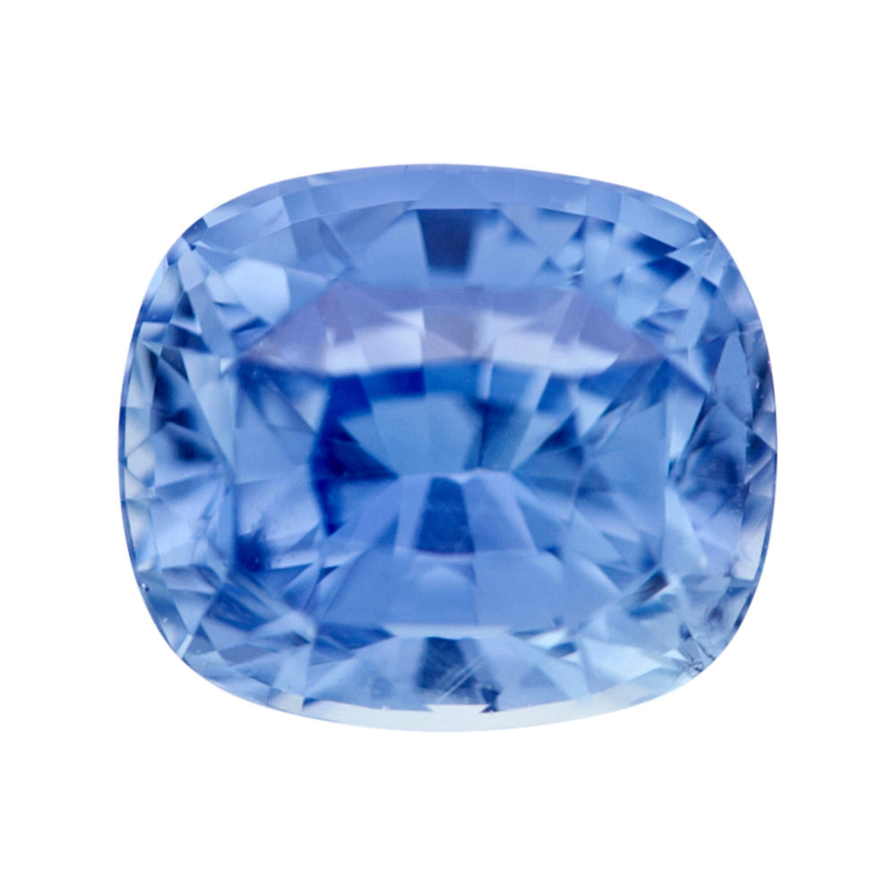 Front view of a natural, loose blue Ceylon cushion sapphire on a white background.