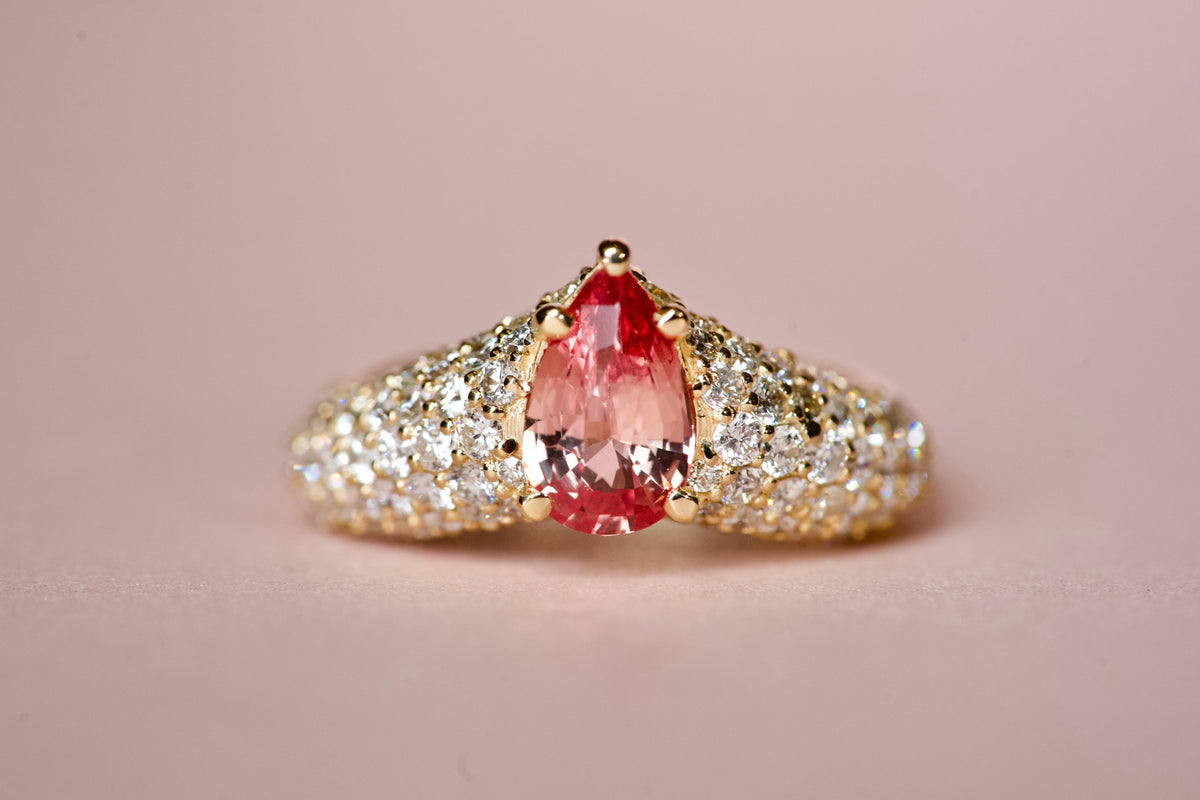 Padparadscha sapphire pear ring with diamond pavé