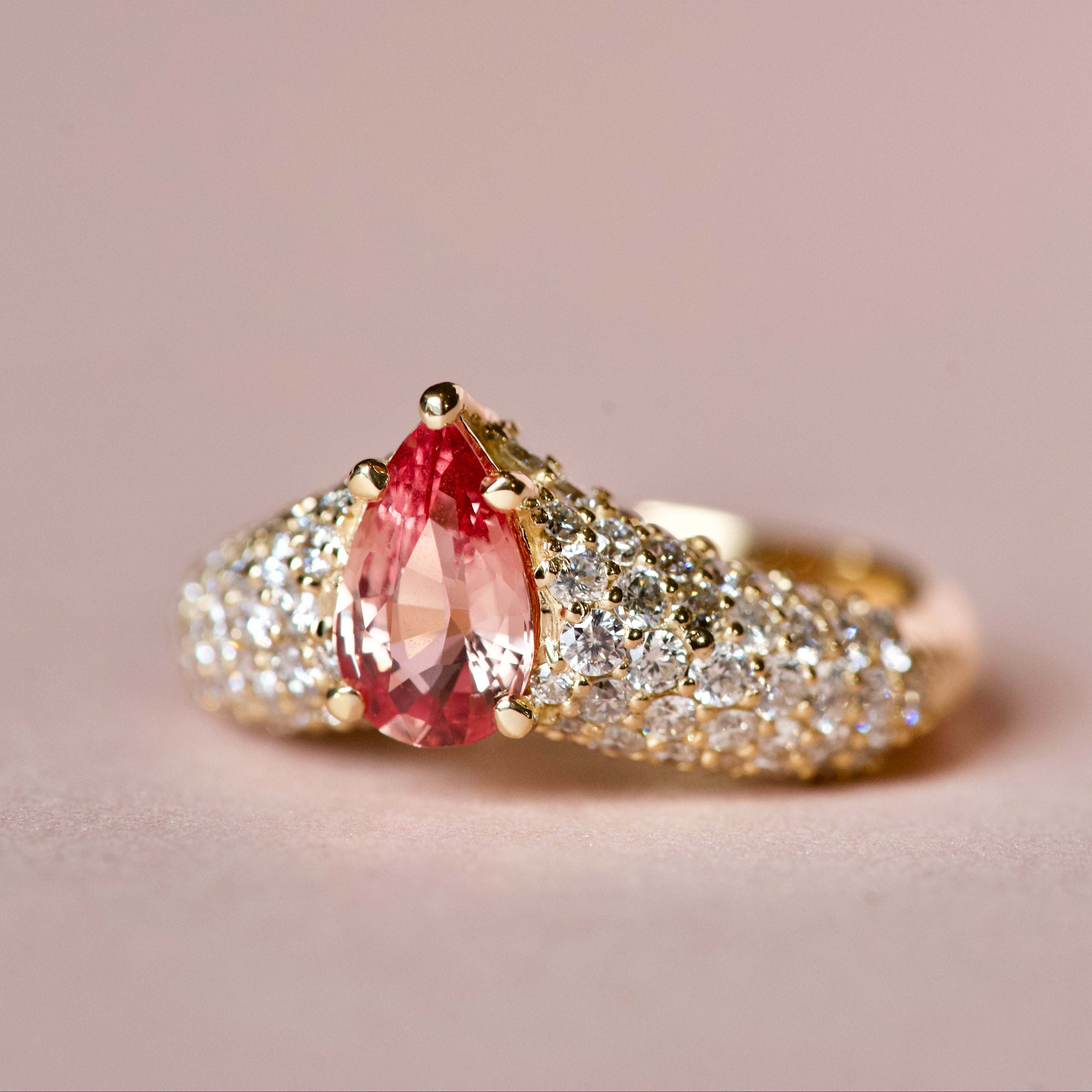 Pinkish orange sapphire ring with diamonds, angle