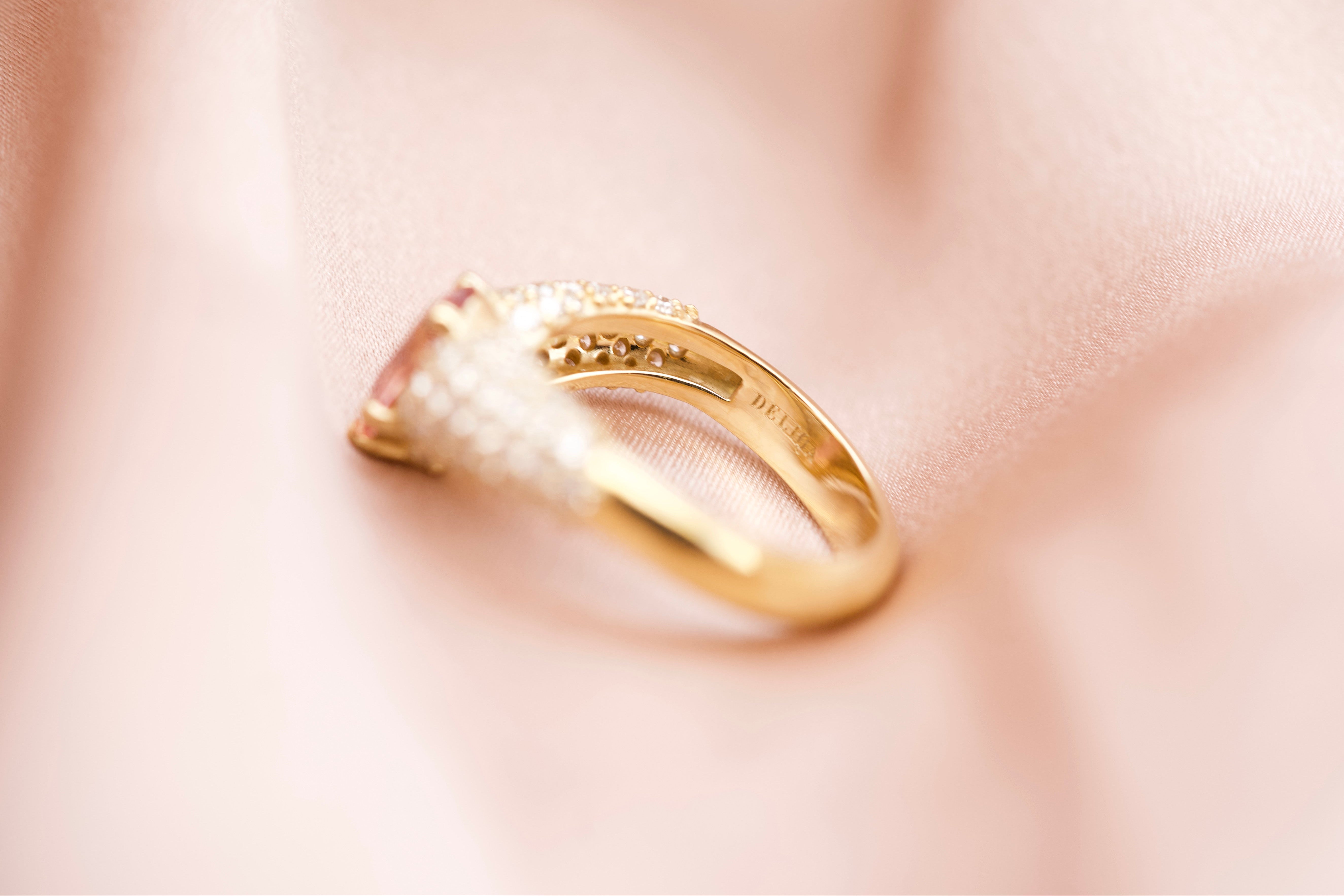 Padparadscha sapphire ring showing gold hallmark