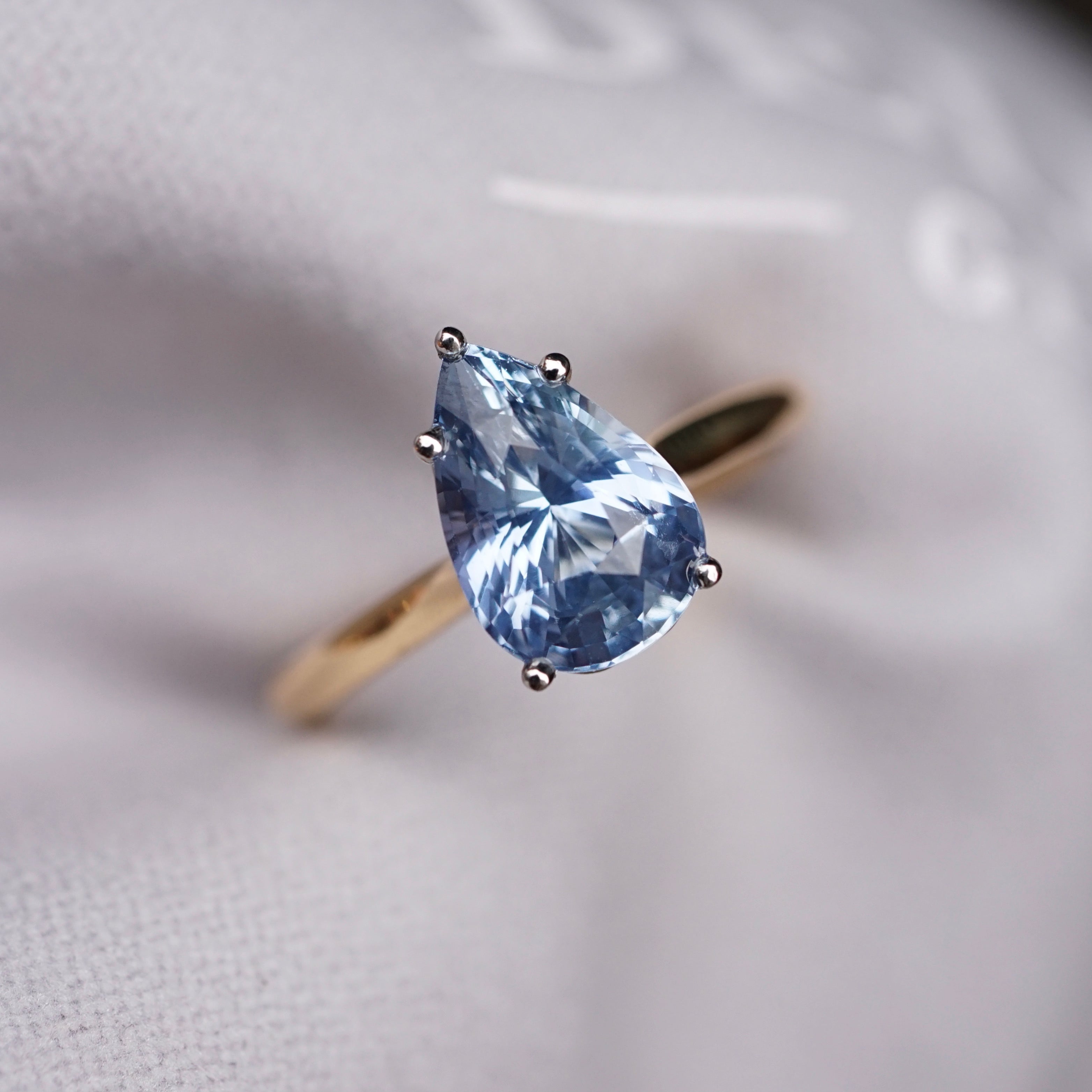 custom jewelry blue ceylon pear sapphire ring in white and yellow gold