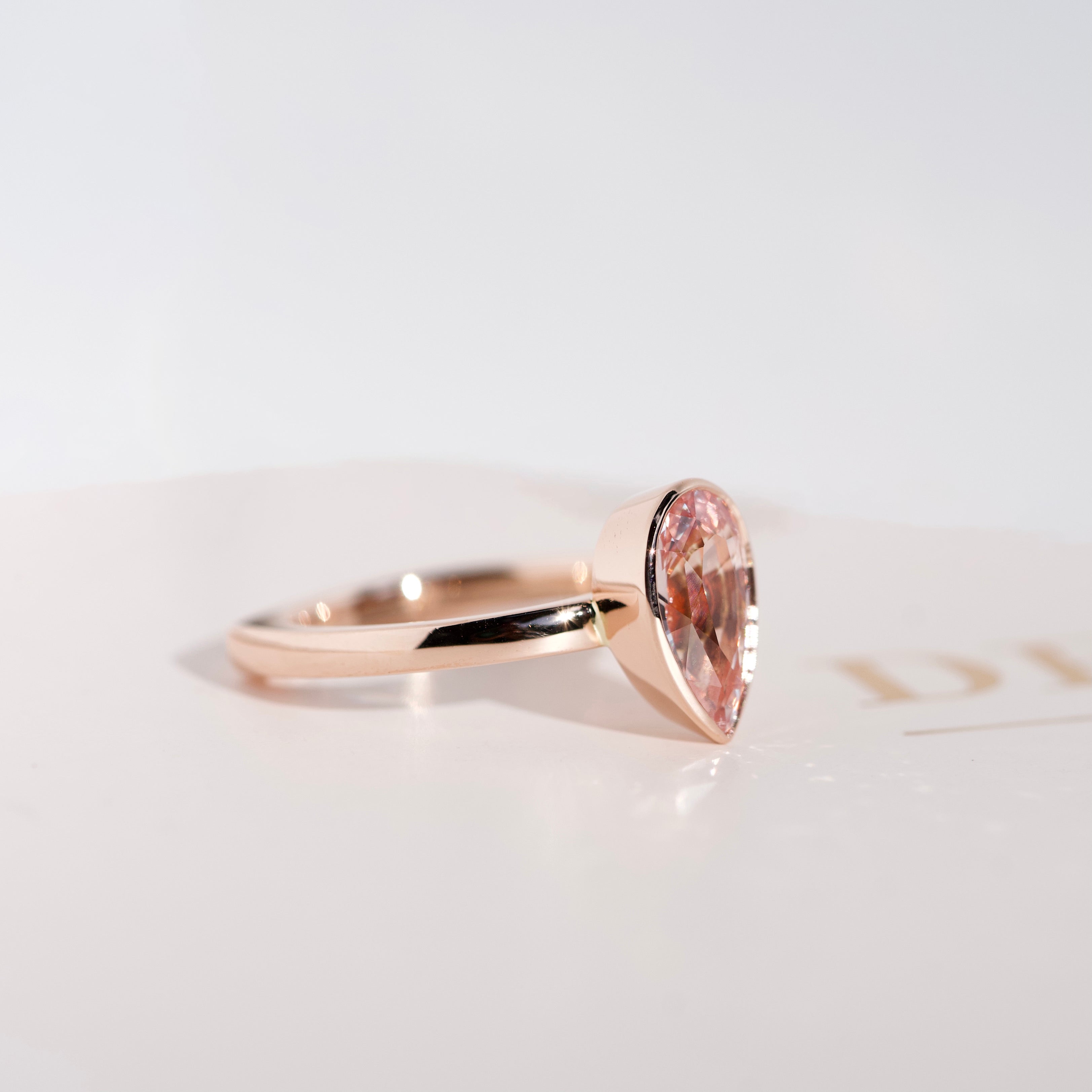 Peach Sapphire Pear Solitaire Bezel Set Rose Gold Ring