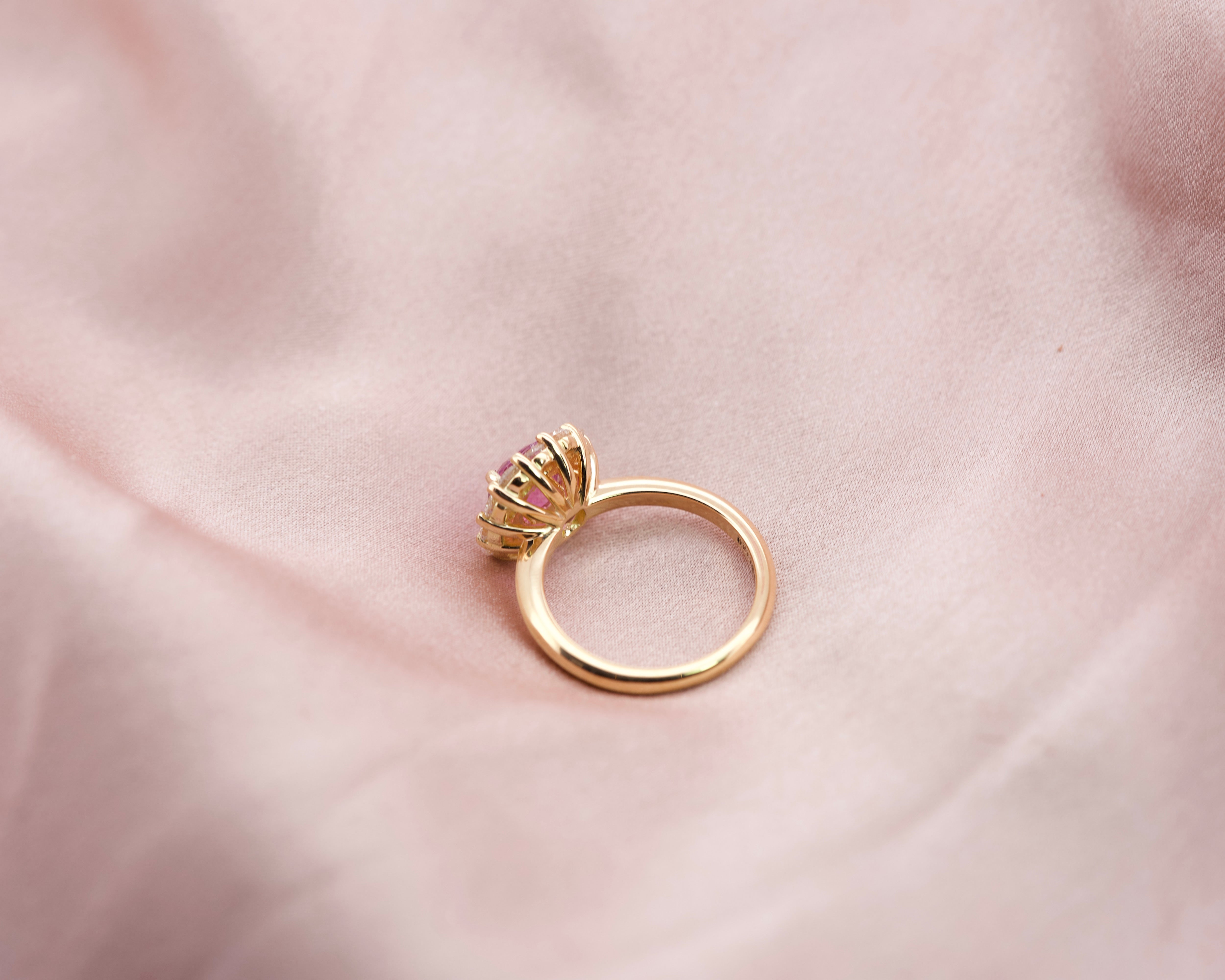 Pink sapphire diamond halo ring, side angle view