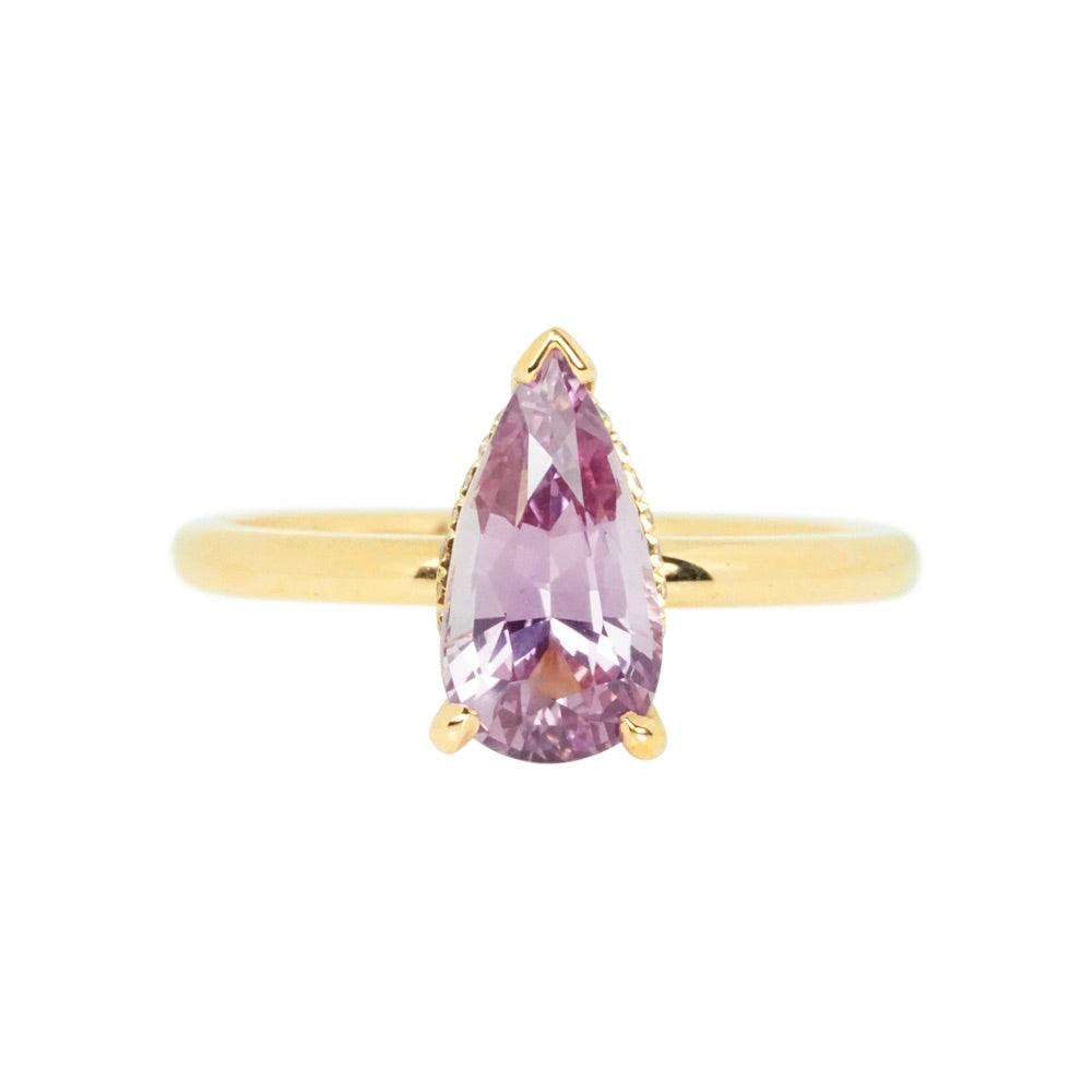 Pear shaped pink sapphire engagement ring in yellow gold