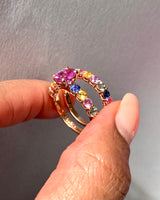 Rainbow sapphire wedding set worn on hand, lifestyle shot