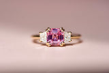Emerald cut pink sapphire with diamond side stones