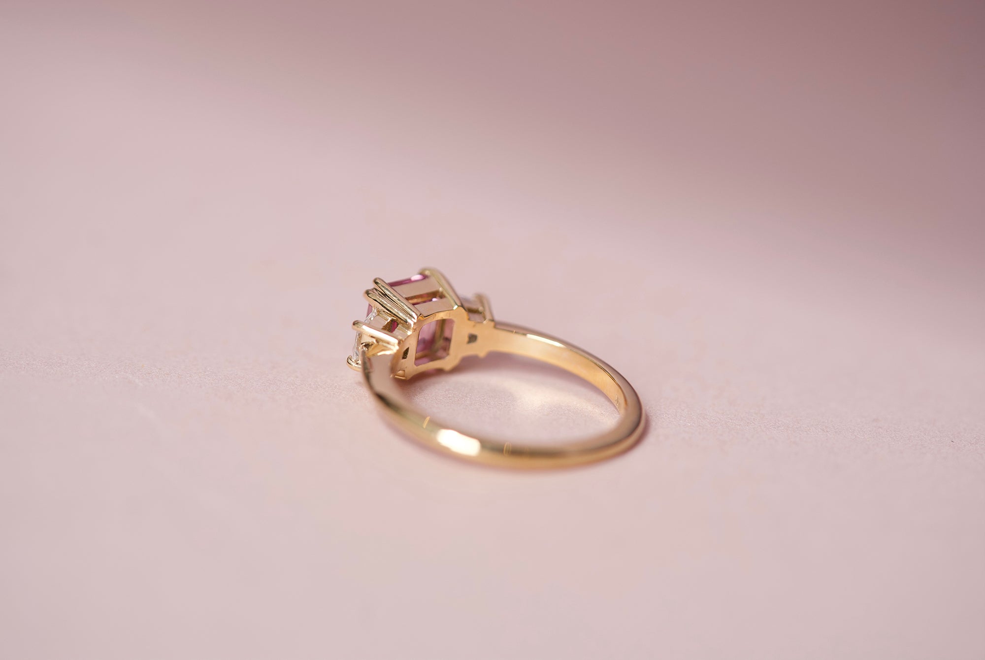 Pink sapphire ring with trapezoid diamonds, side view
