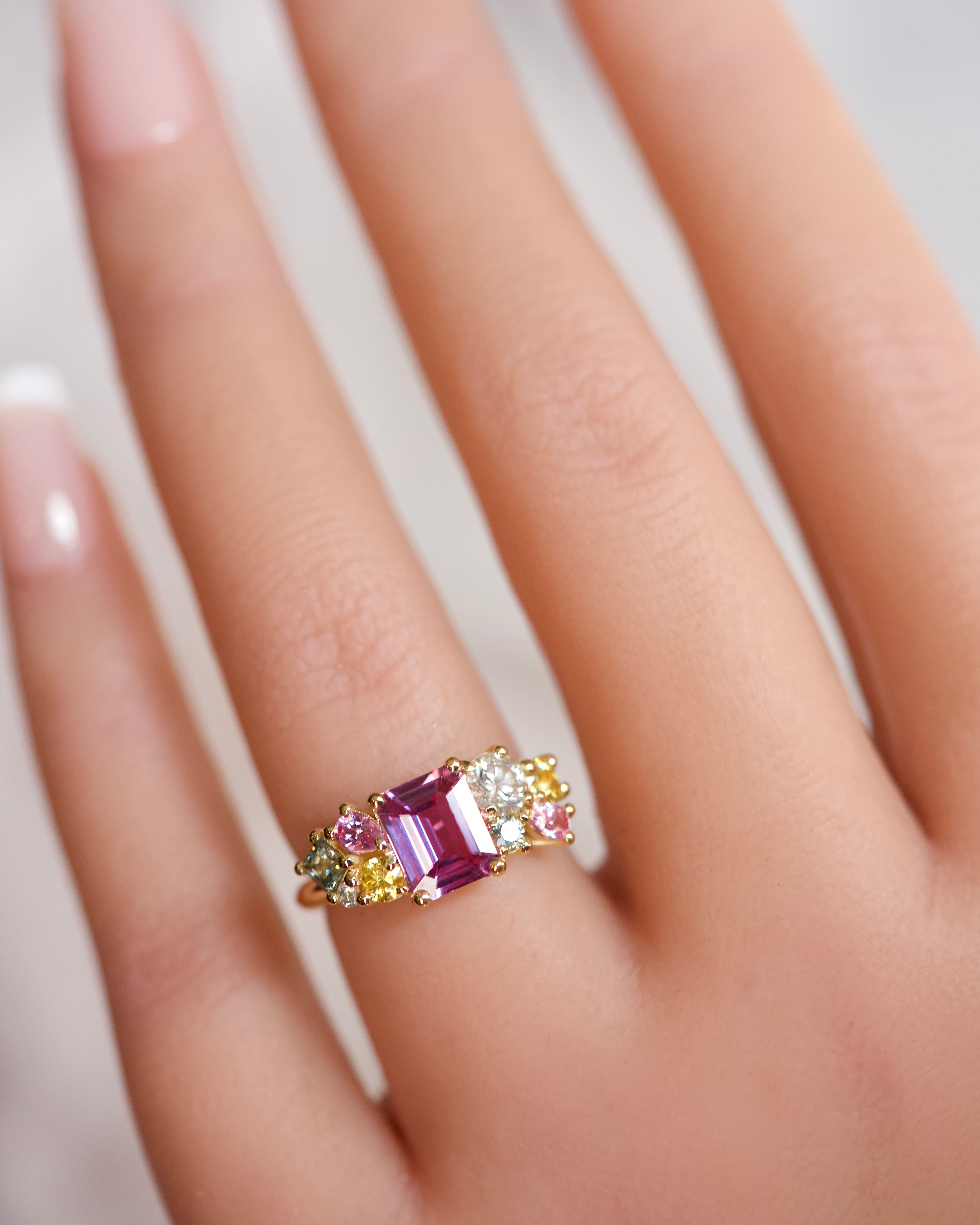 ring with a cluster of sapphires in multiple colors