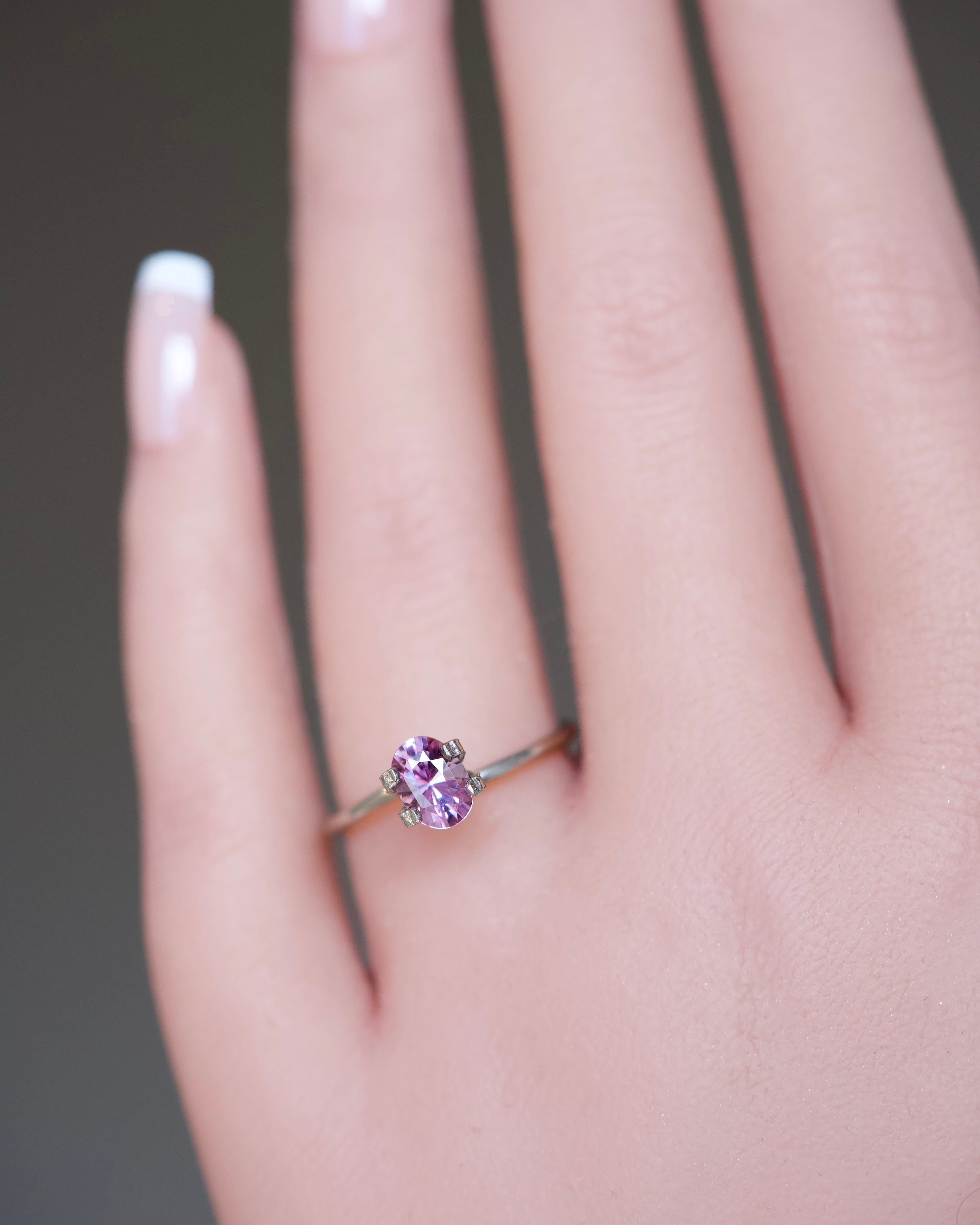 An unheated oval mixed-cut purplish pink sapphire from Ceylon showing dual-toned chromatic depth.