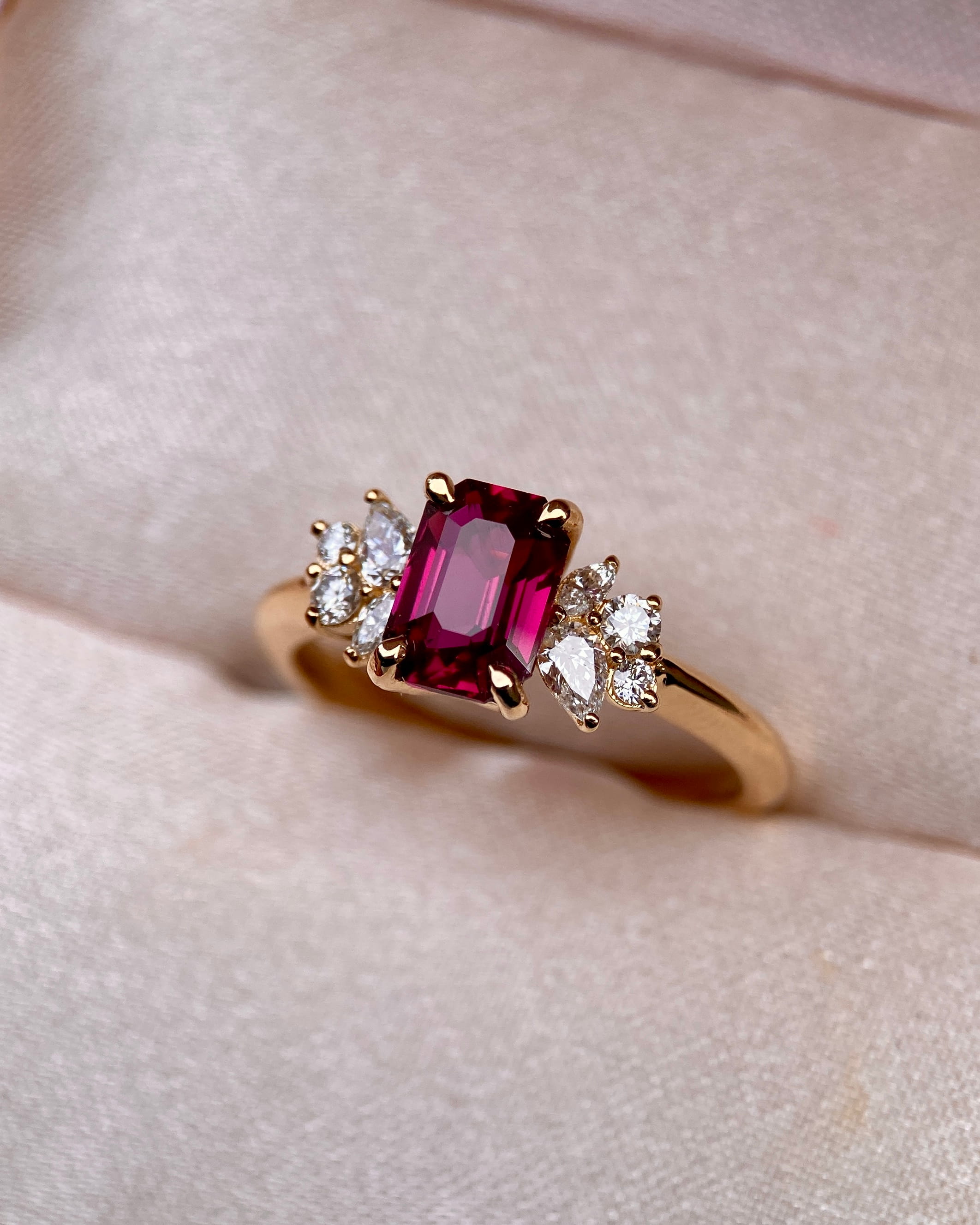 Bespoke unheated red ruby step cut ring sitting elegantly inside a fabric ring box slot