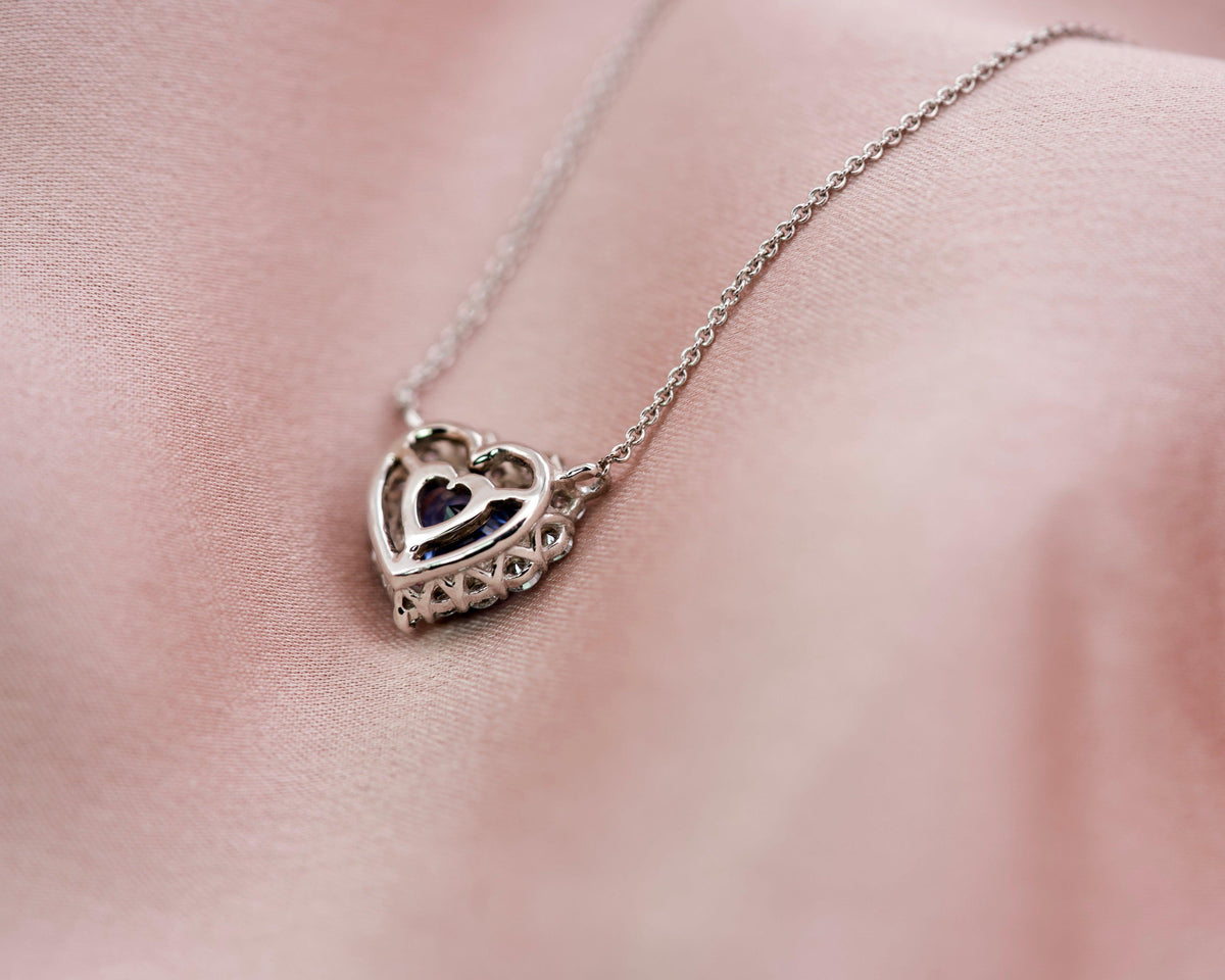 Reverse view of a sapphire heart pendant illustrating the intricate white gold basket work
