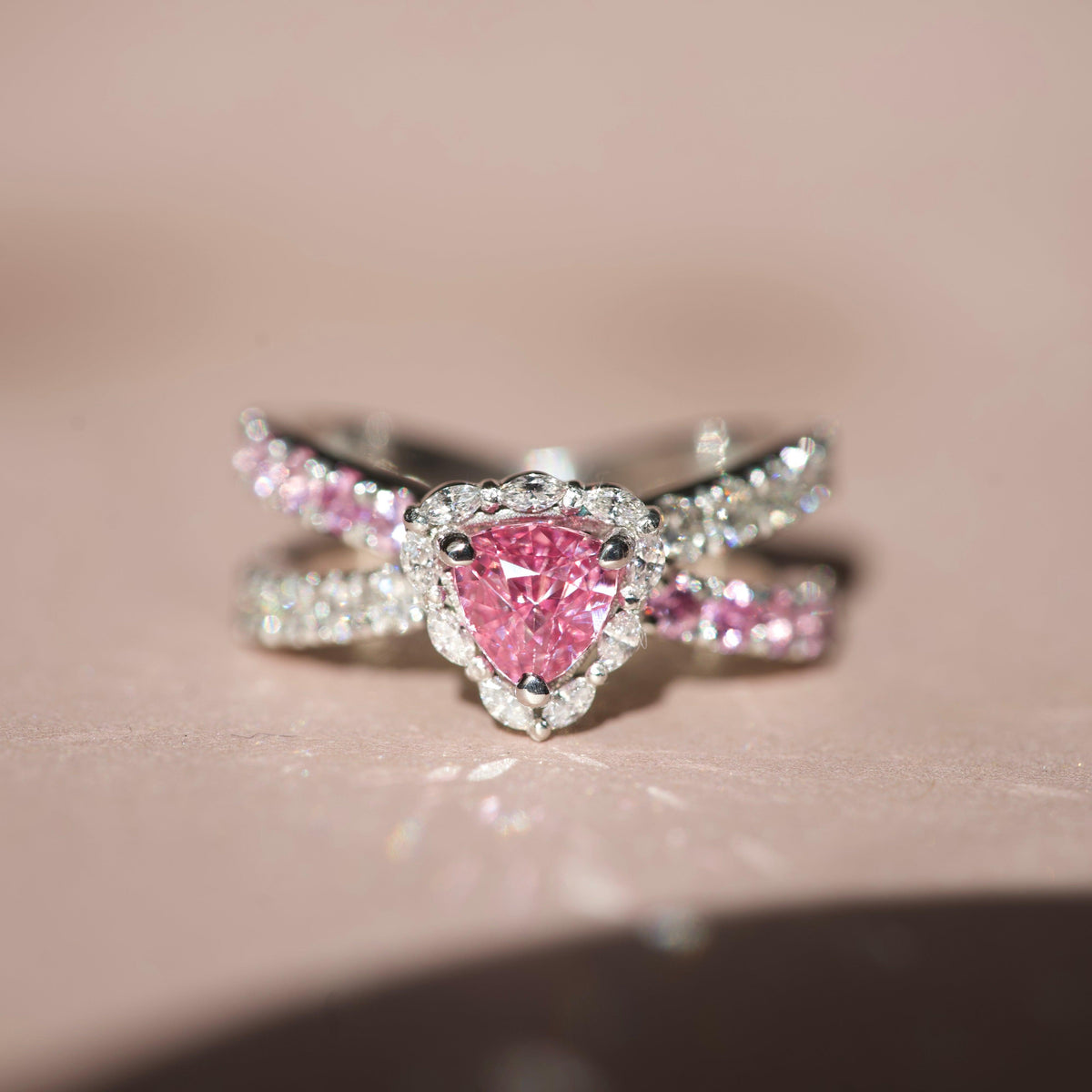 Close-up of a 1.10ct unheated Ceylon pink sapphire ring with a trillion diamond halo