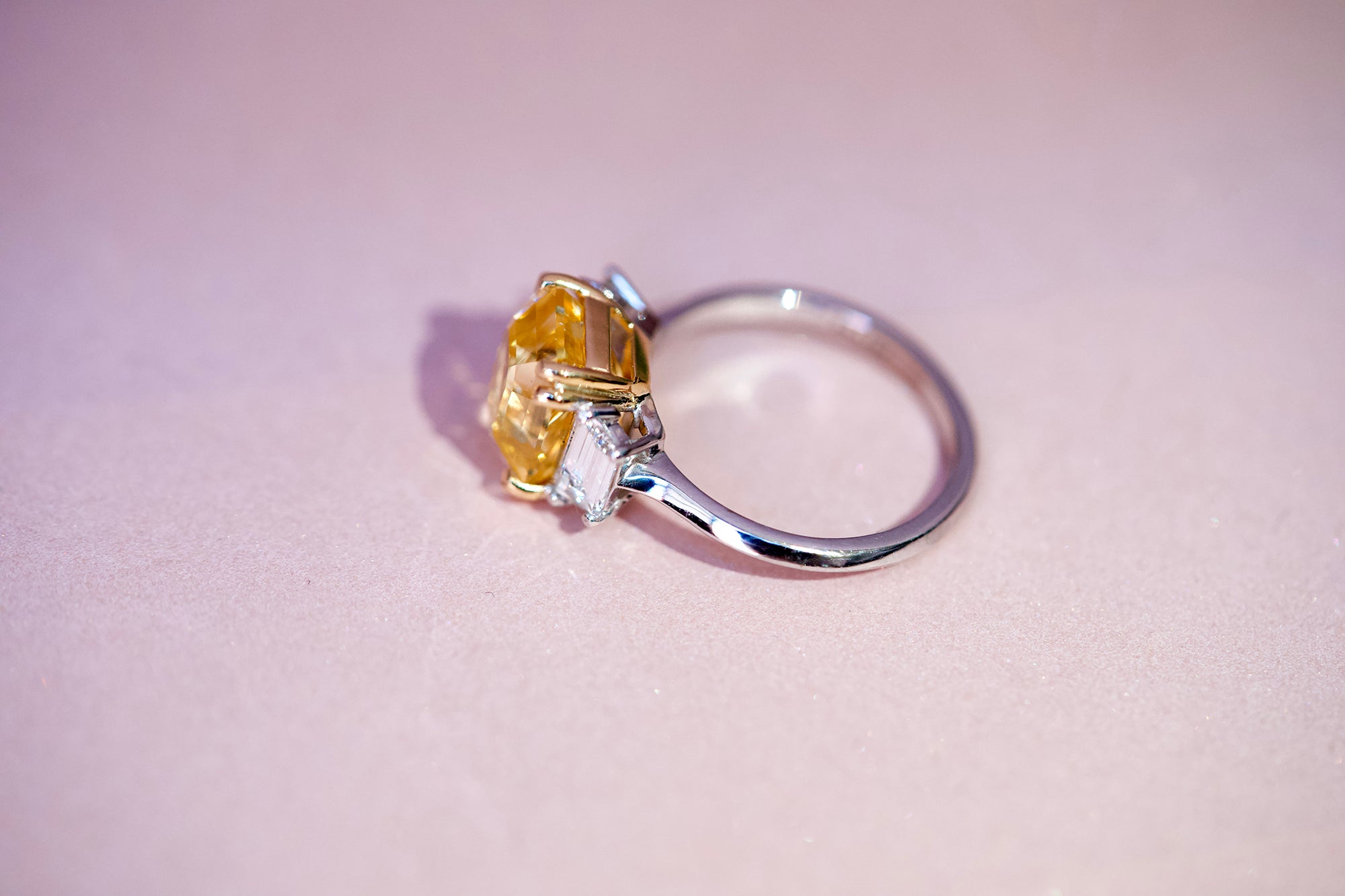 Yellow sapphire three stone ring with diamonds, angle