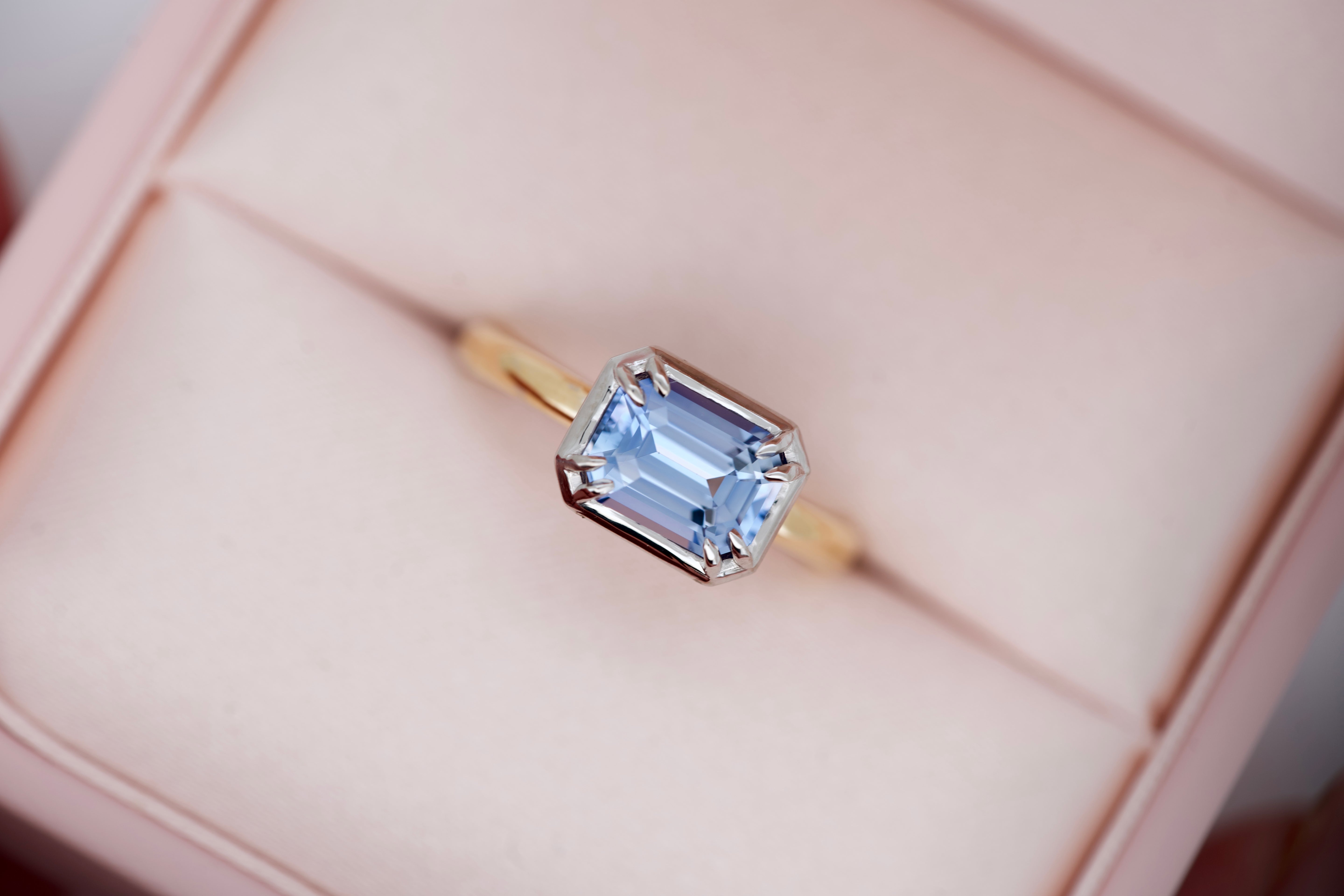 Close-up two-tone sapphire engagement ring