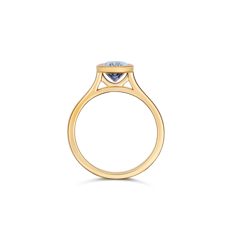 Oval sapphire bezel ring in yellow gold, side profile view