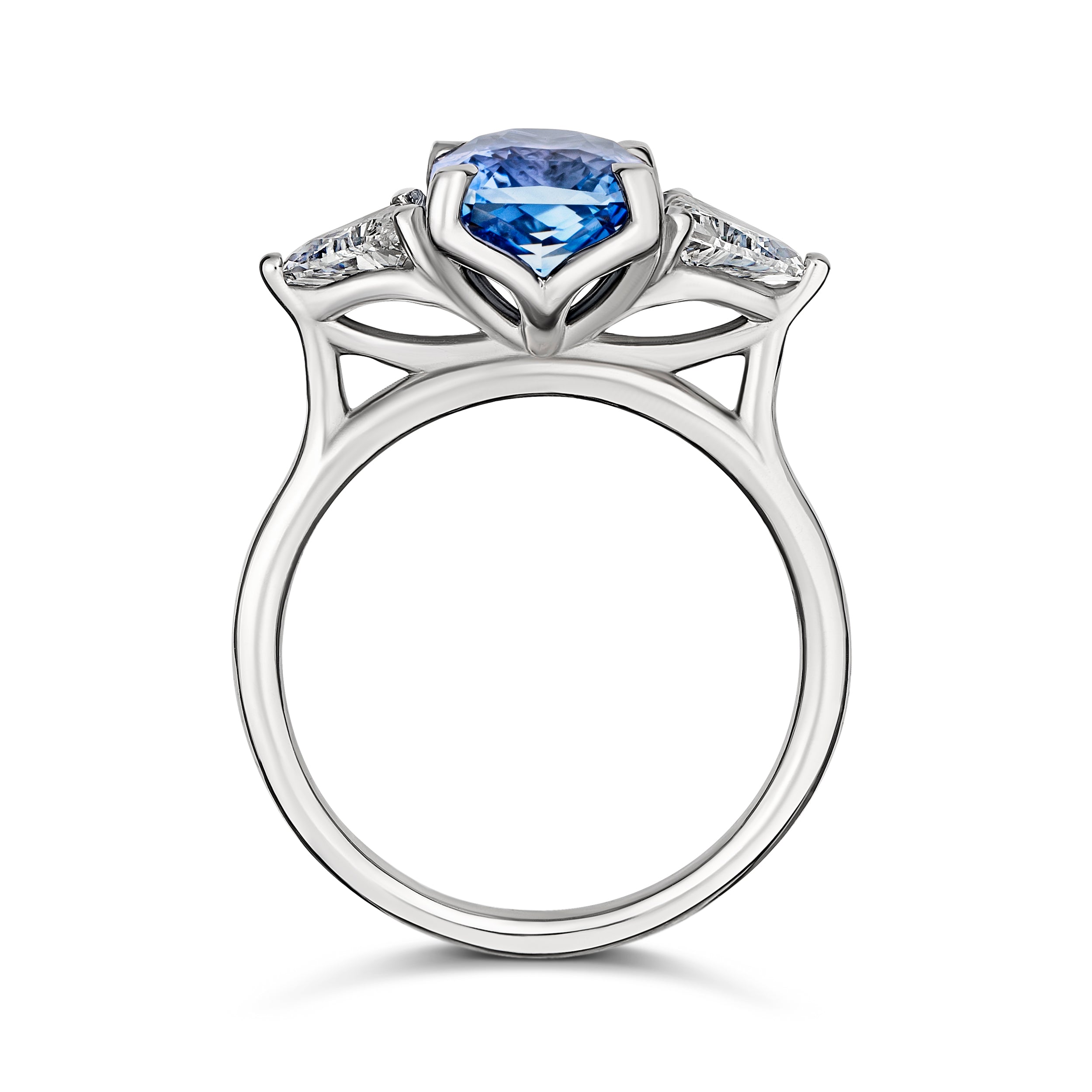 Medium blue sapphire engagement ring with trillion diamonds