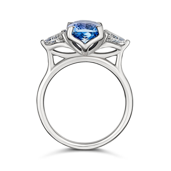 Medium blue sapphire engagement ring with trillion diamonds