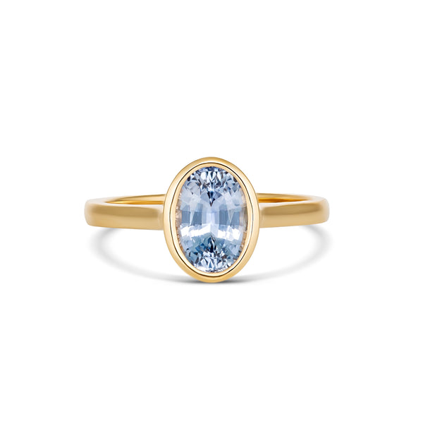 Sky blue oval Ceylon sapphire in yellow gold bezel setting