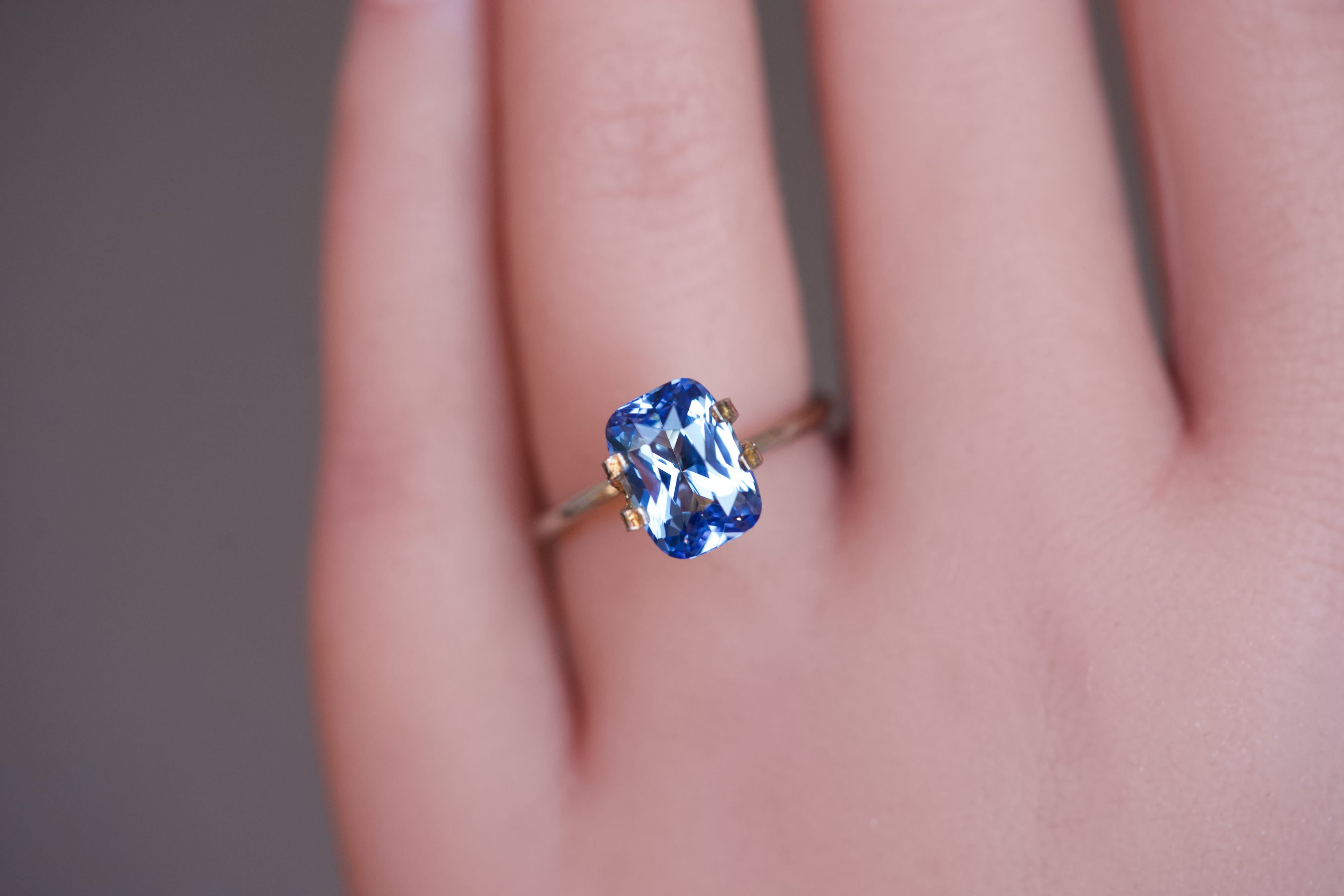 Unheated blue Ceylon cushion sapphire worn in a temporary ring setting.
