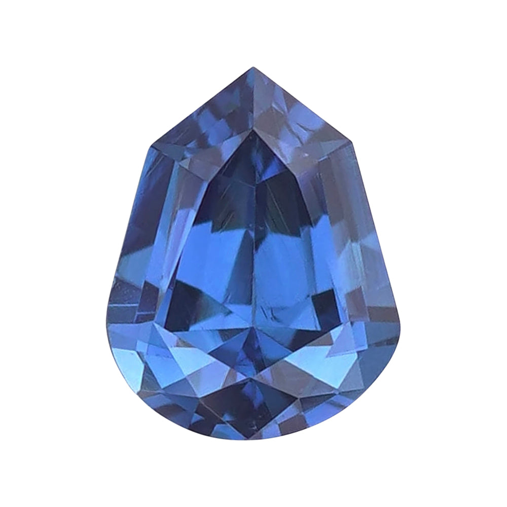 Elongated shield-shaped vibrant blue loose sapphire featuring sharp geometric crown facets.
