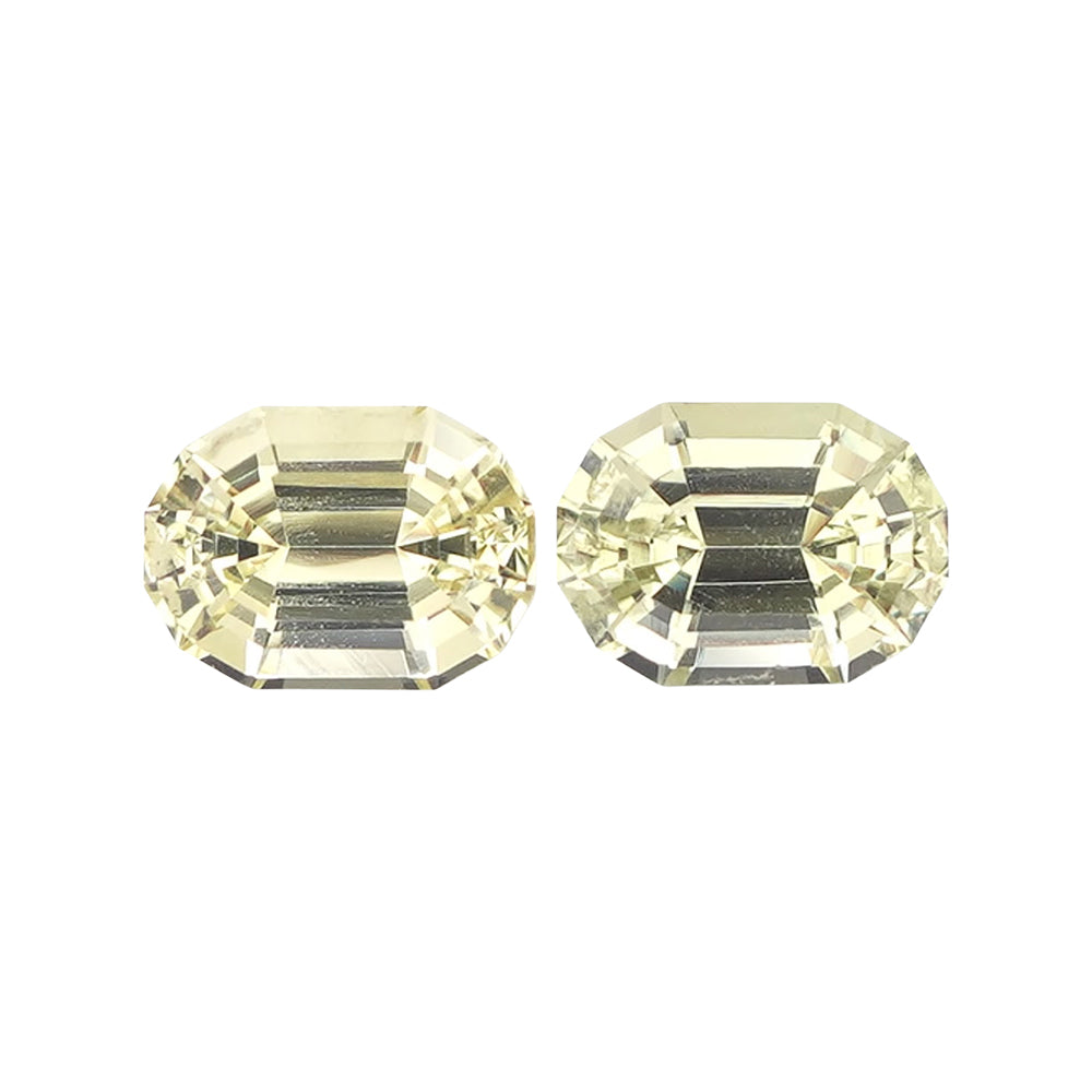 Matched set of two light yellowish green rectangular step-cut stones.