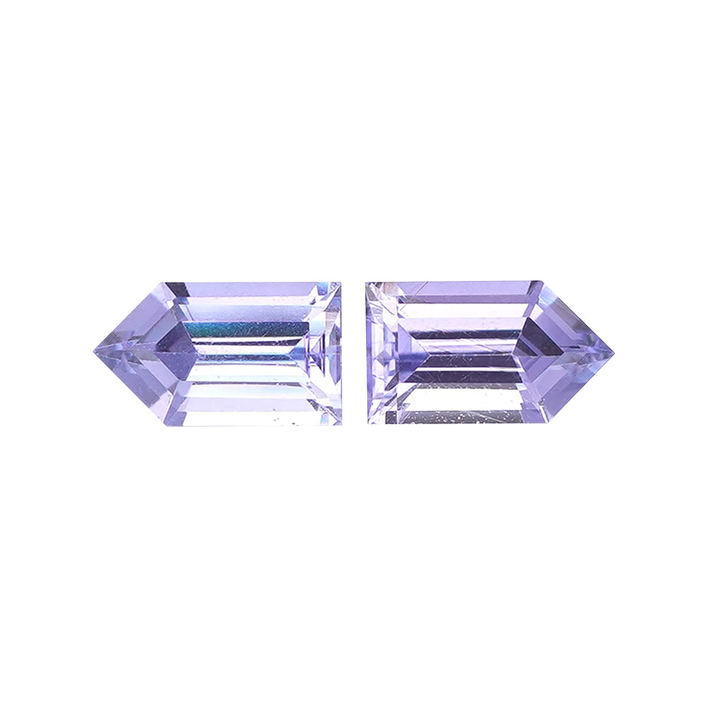 Matched pair of light violet-blue geometric arrowhead-cut loose gemstones.