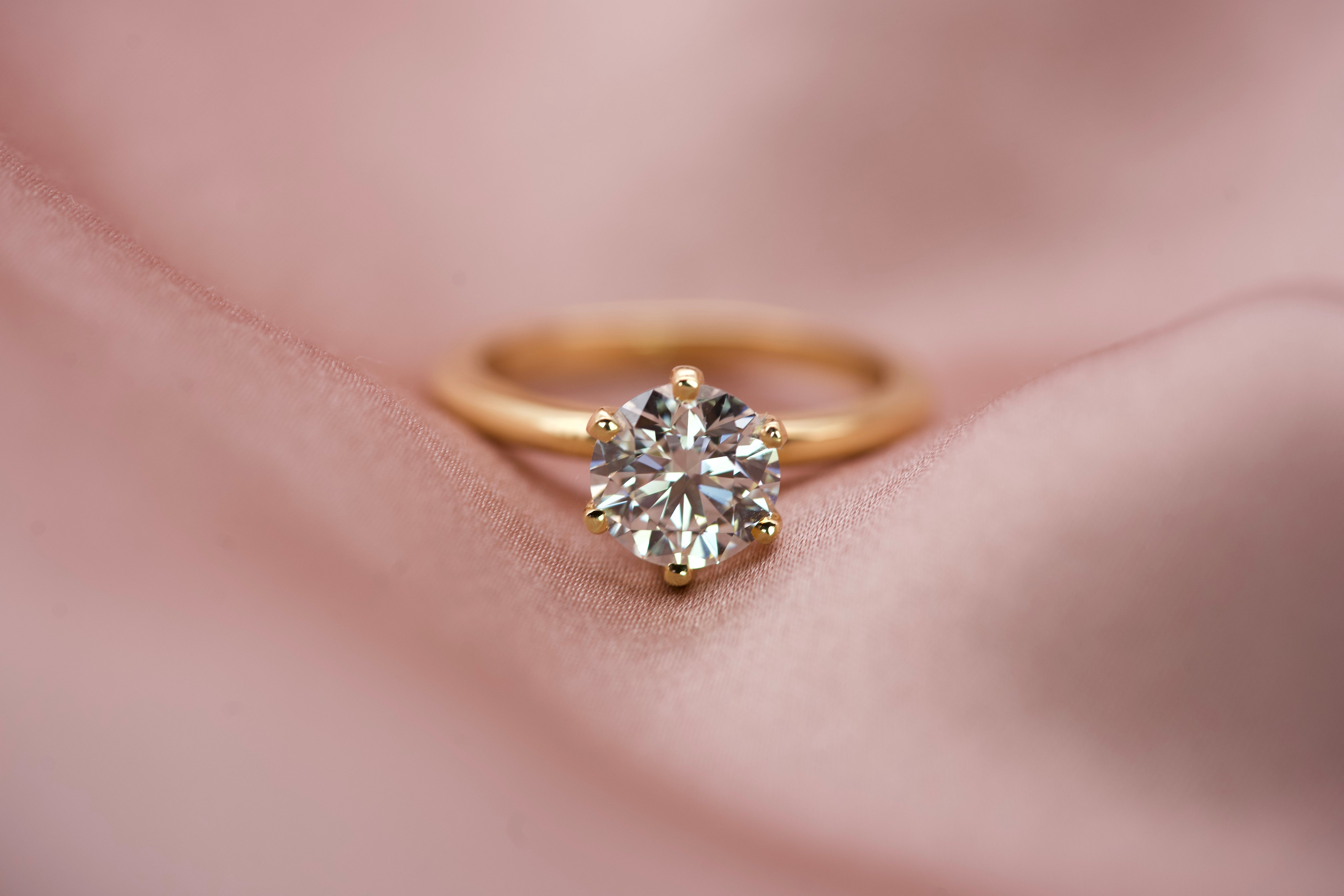 Detailed top-down view of a 1.50 carat GIA certified diamond on pink silk