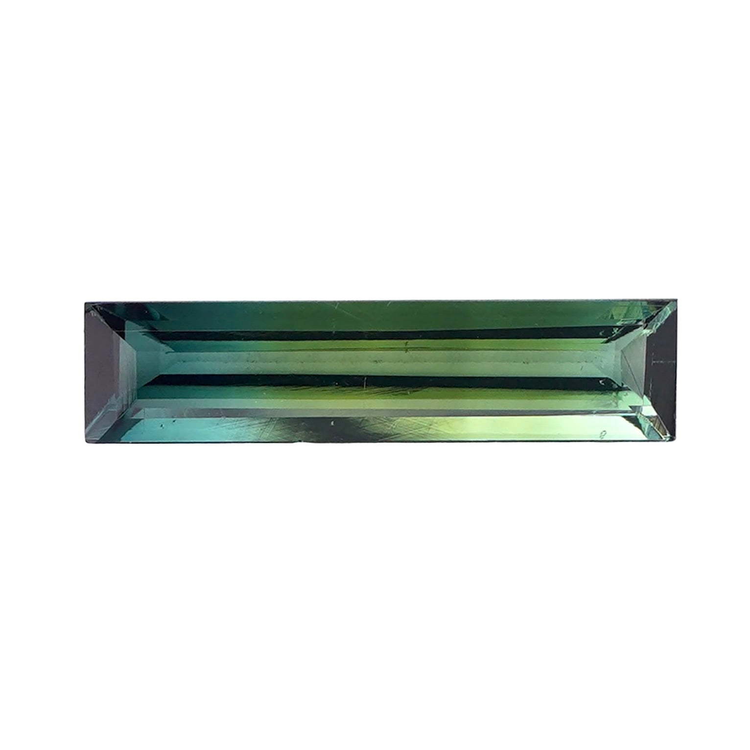 Loose elongated green tourmaline with a rectangular step cut on a white background.