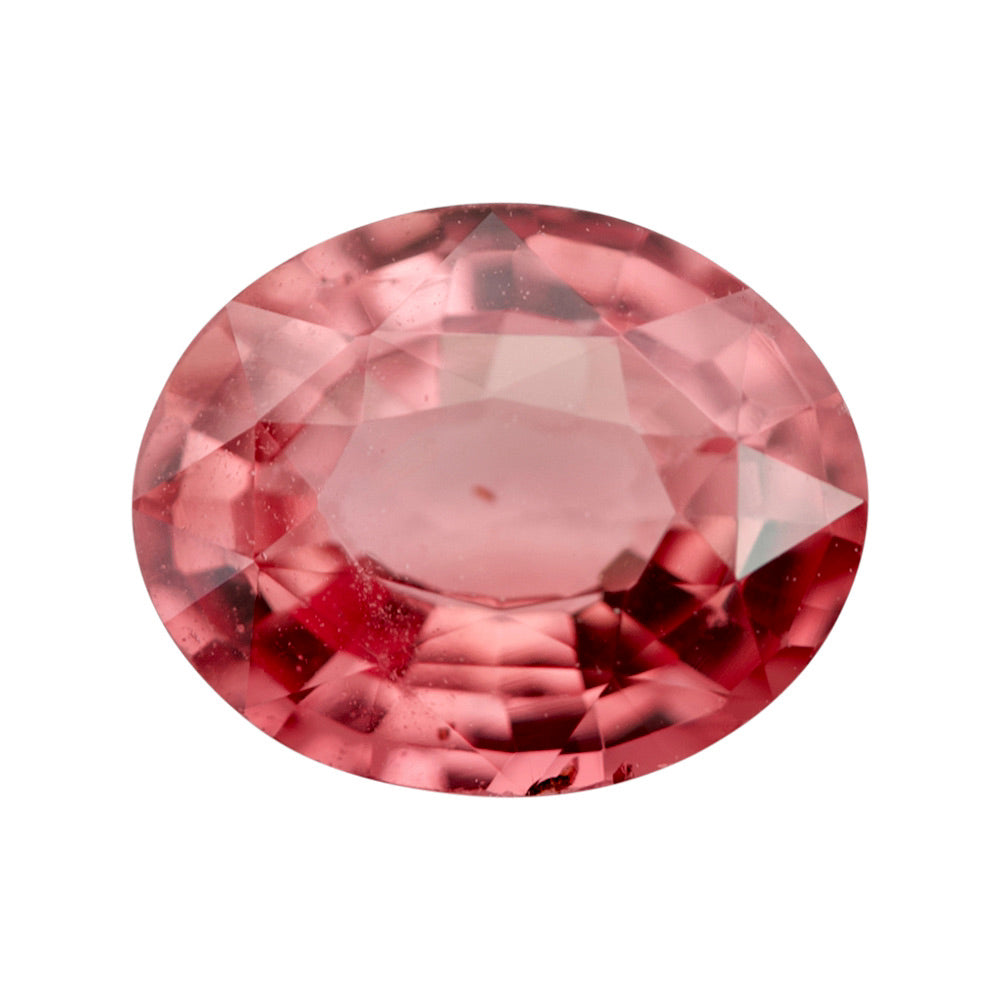 Front view of a natural, loose pinkish-orange Padparadscha sapphire from Madagascar with an oval step cut, on a white background.