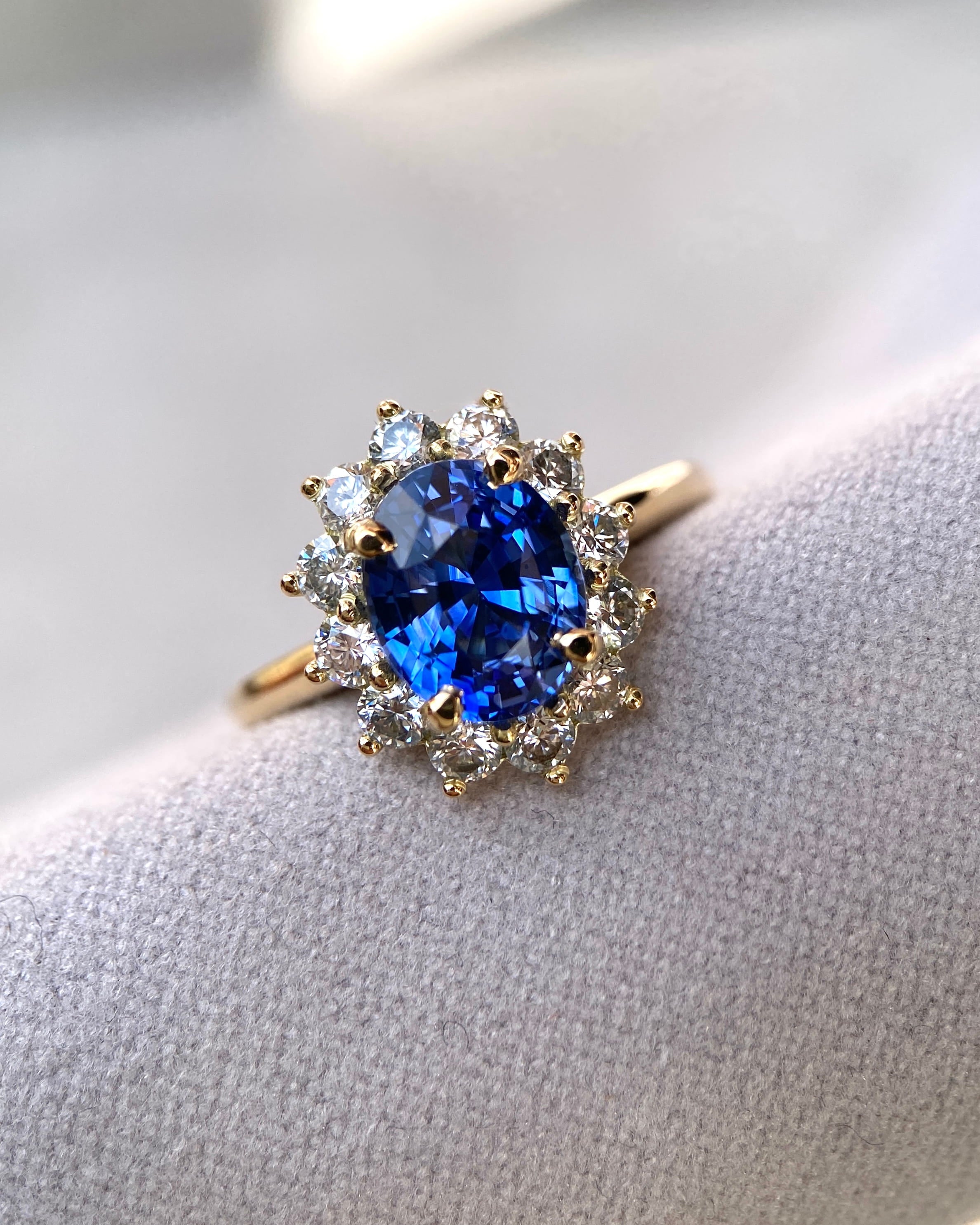 Close up view of a handcrafted 2.54 carat blue sapphire ring showcasing premium diamond claws