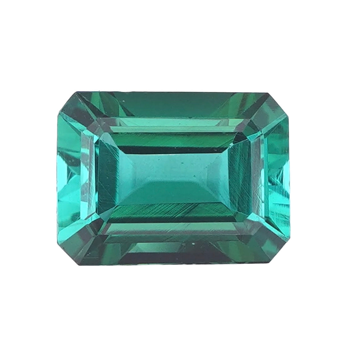 A loose, natural green Tourmaline featuring a rectangular step cut with truncated corners, shown against a white background.