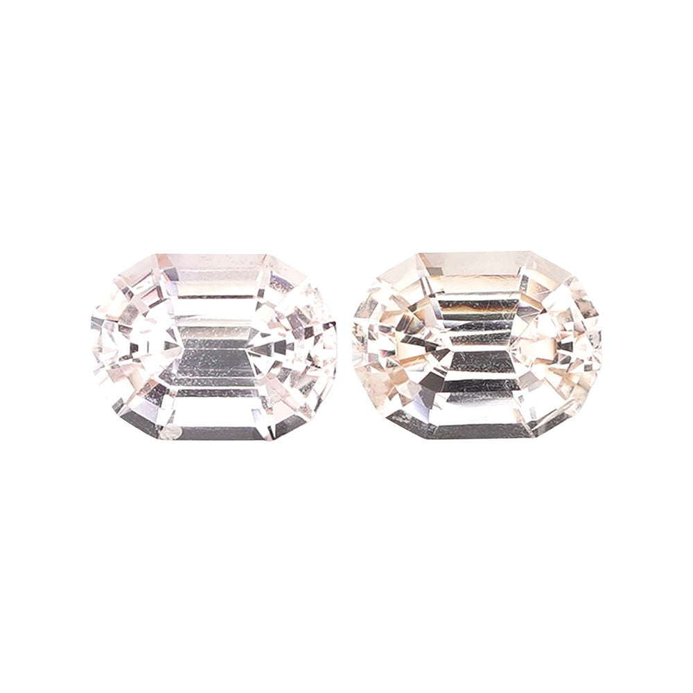 Pair of near-colorless white champagne octagonal step-cut loose gems.